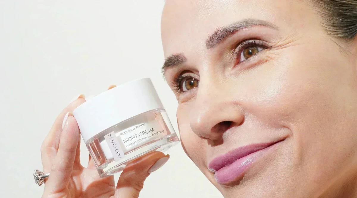 a mature woman holding natural night cream for mature skin
