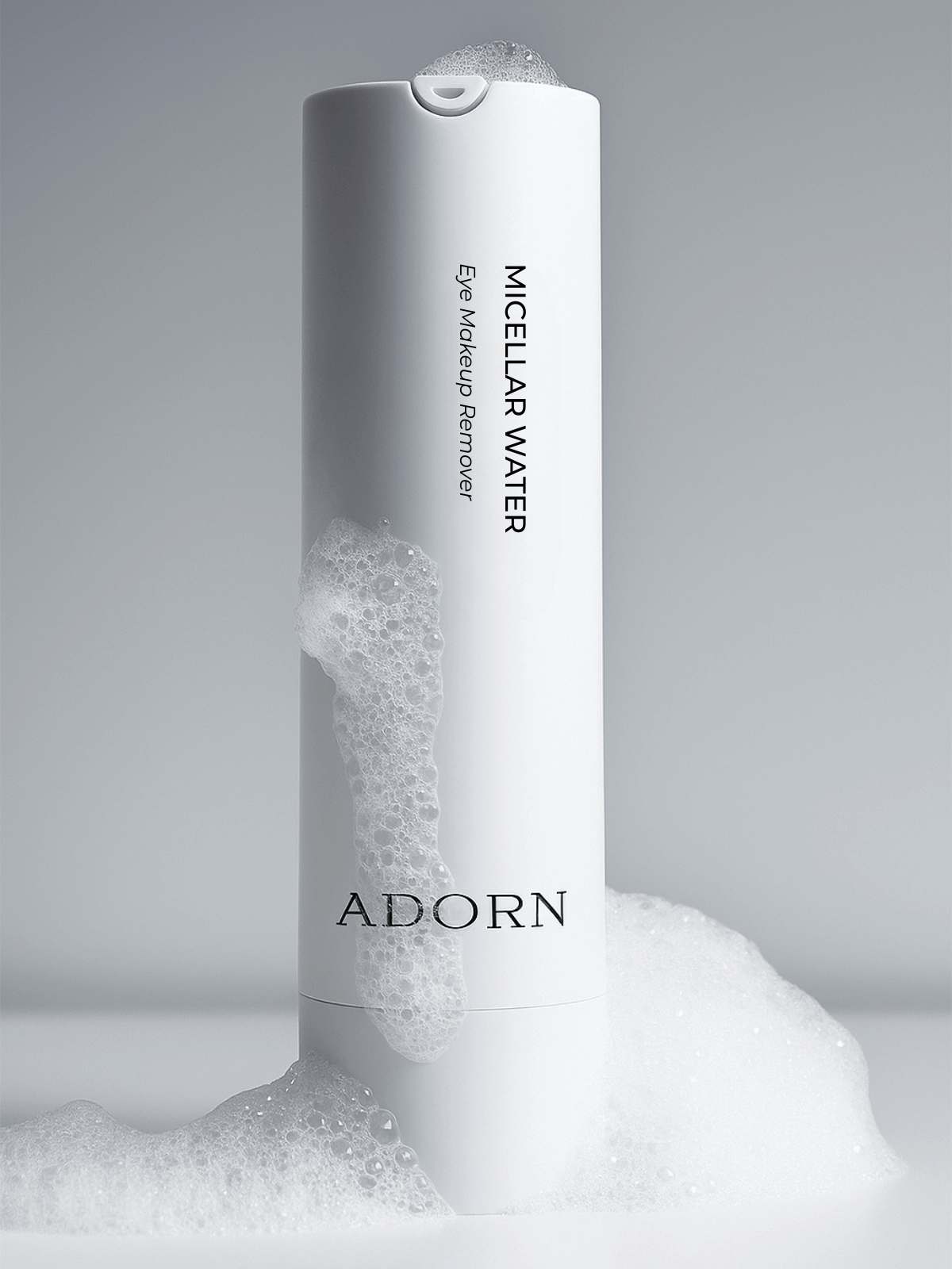 Adorn Micellar Water bottle with foamy texture on a gray background