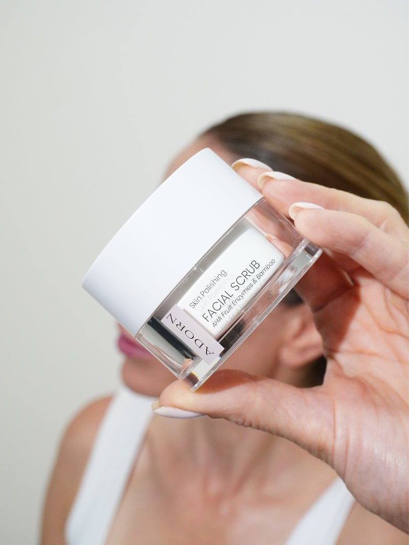 best natural face exfoliator in model's hand, natural skincare by Adorn Cosmetics.