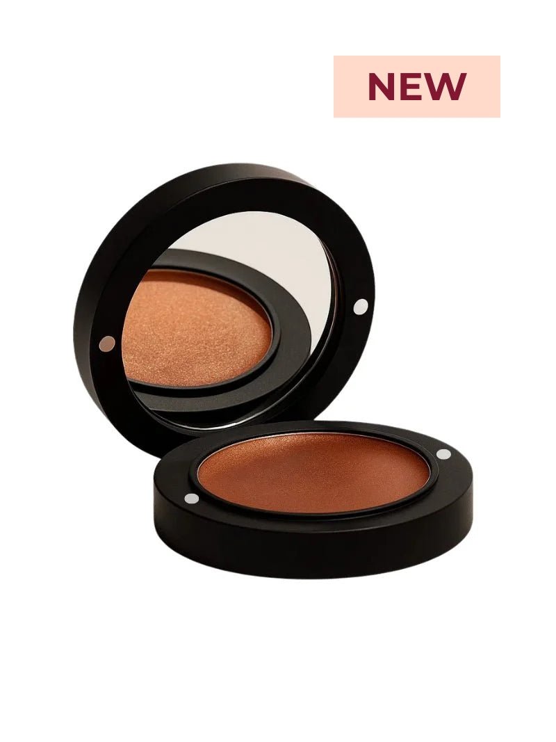 Mineral makeup compact stack with cream bronzer and mirror lid on a white background.