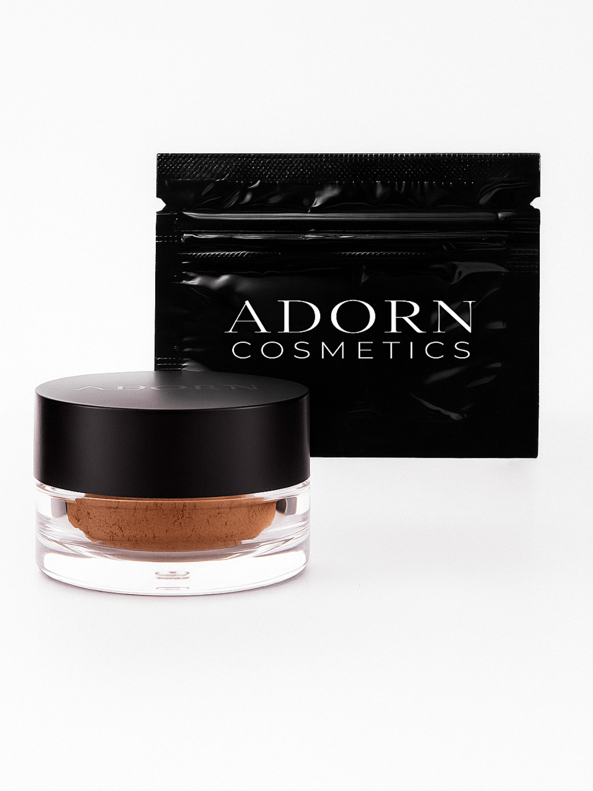 Best eyebrow powder in a clear container with a black lid, next to an Adorn Cosmetics packaging on a white background.