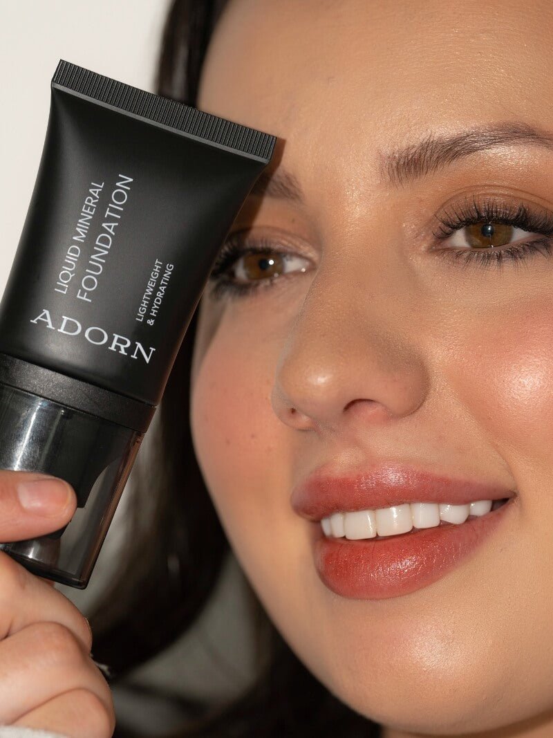 Natural Mineral Foundation + Ceramide Liquid packaging being held by a beautiful woman.