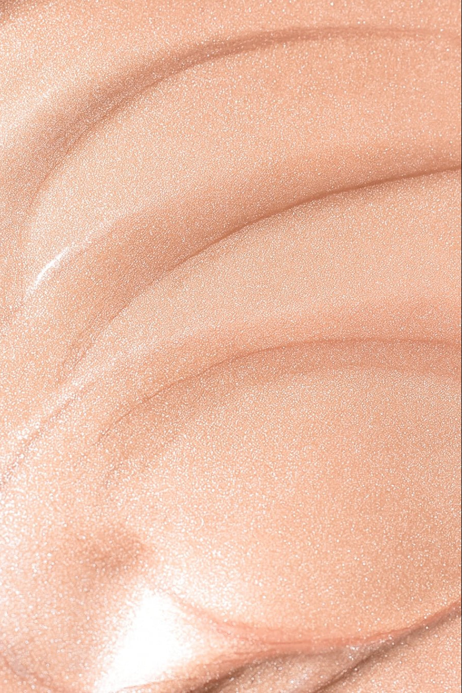 Liquid illuminator swatch on tanned skin — warm golden finish