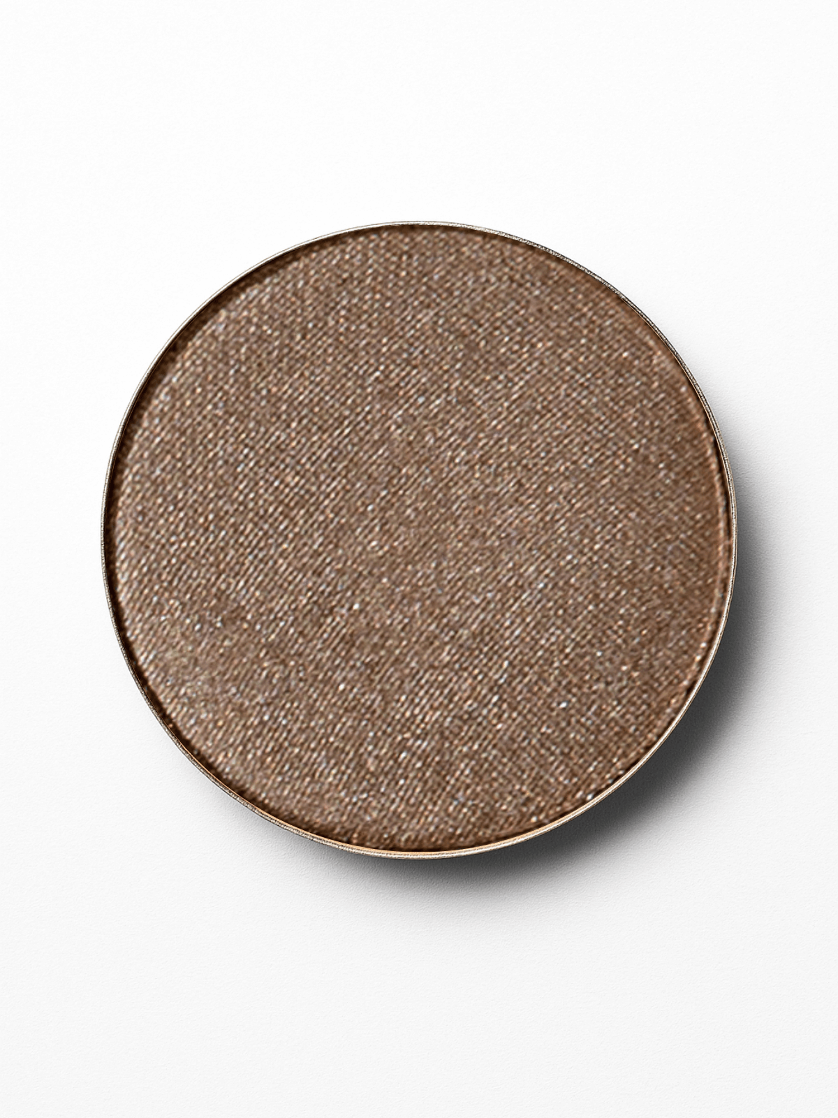 Round brown mineral eyeshadow in a ceramic plate on a white background
