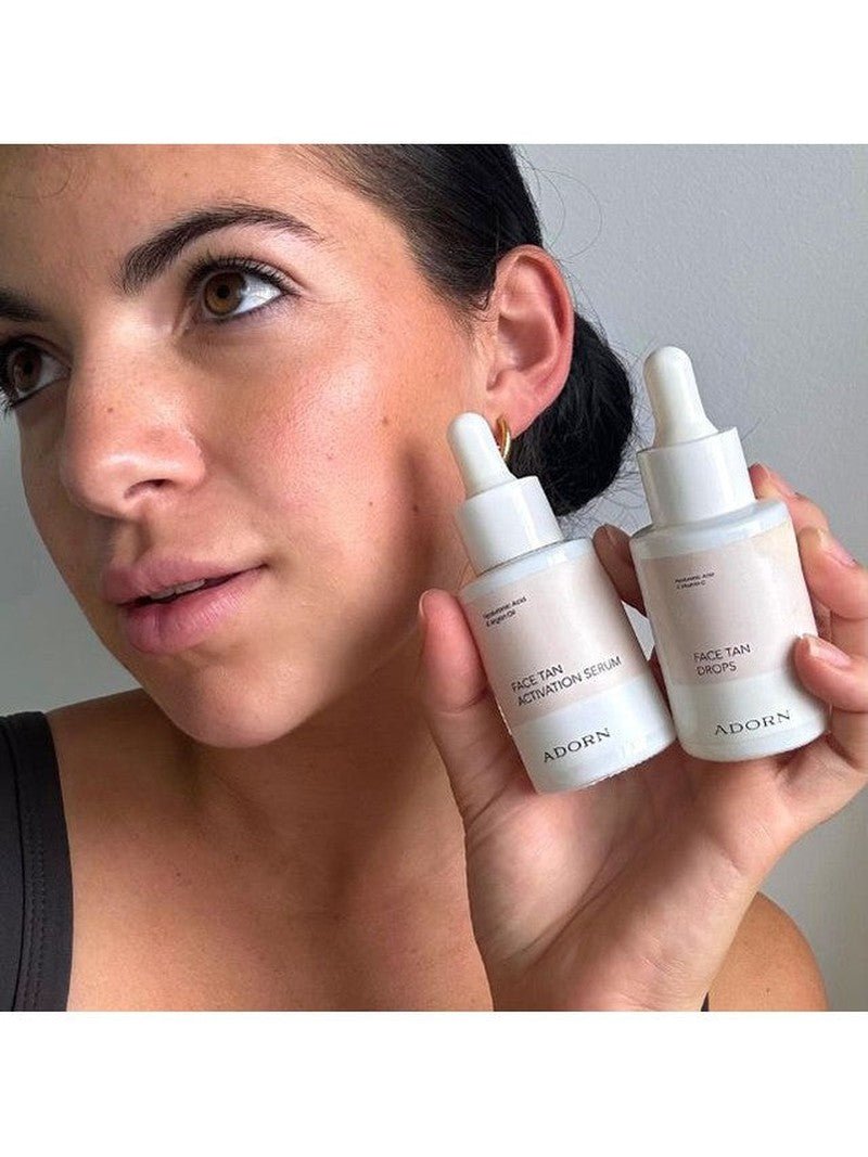 ADORN Face Tan Drops + Activator Serum woman holding natural self tanning drops.