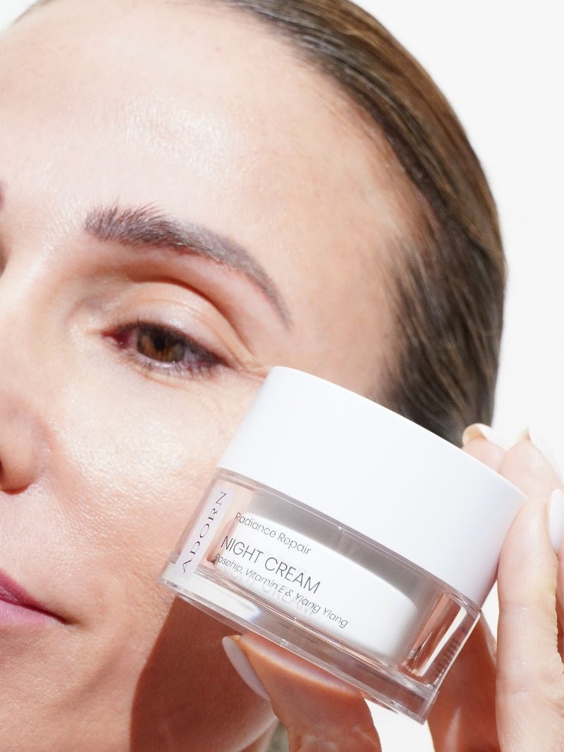 best night cream for glowing skin held in hand close to mature skin model.