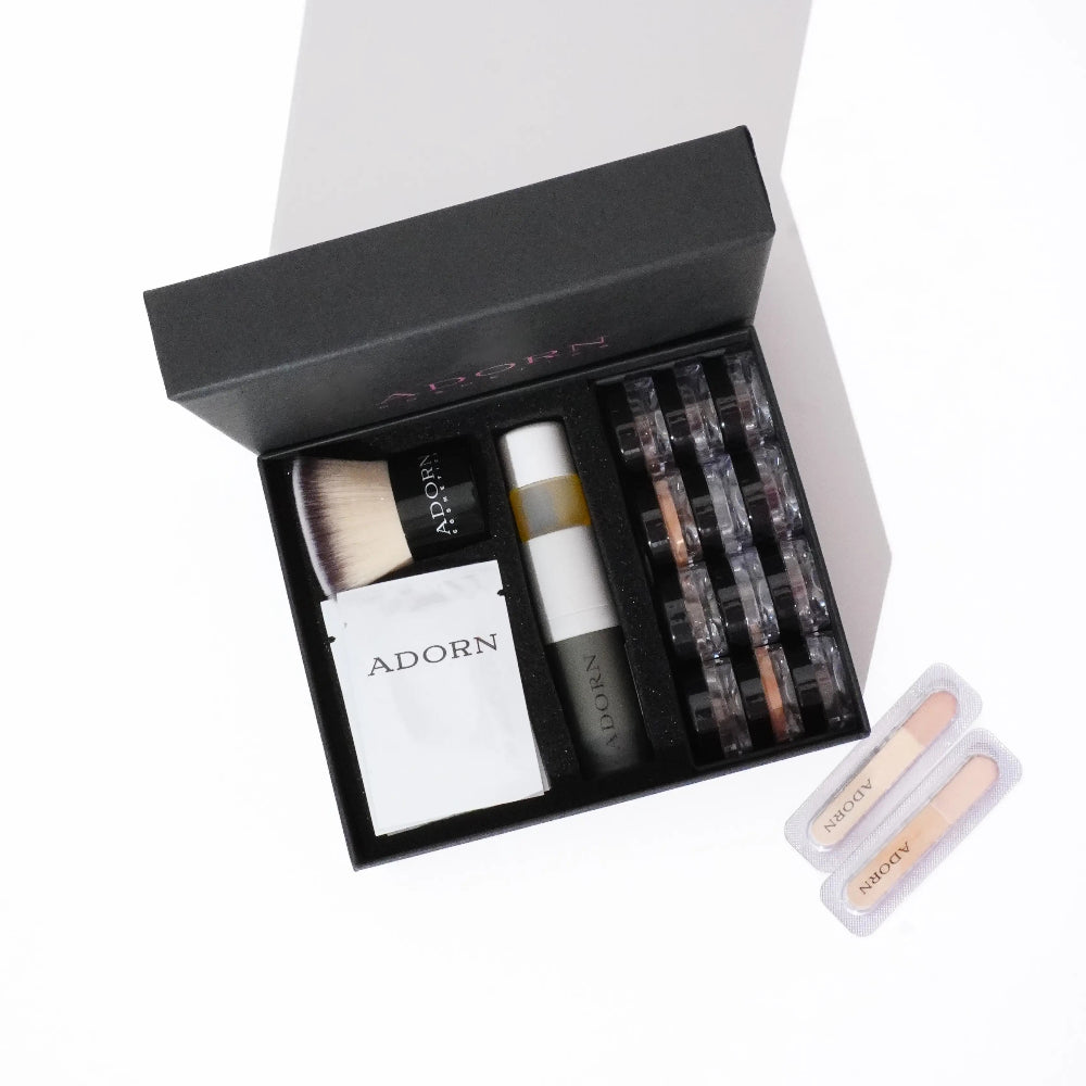 Adorn Cosmetics online foundation samples set including bottles, jars, and a box on a white background