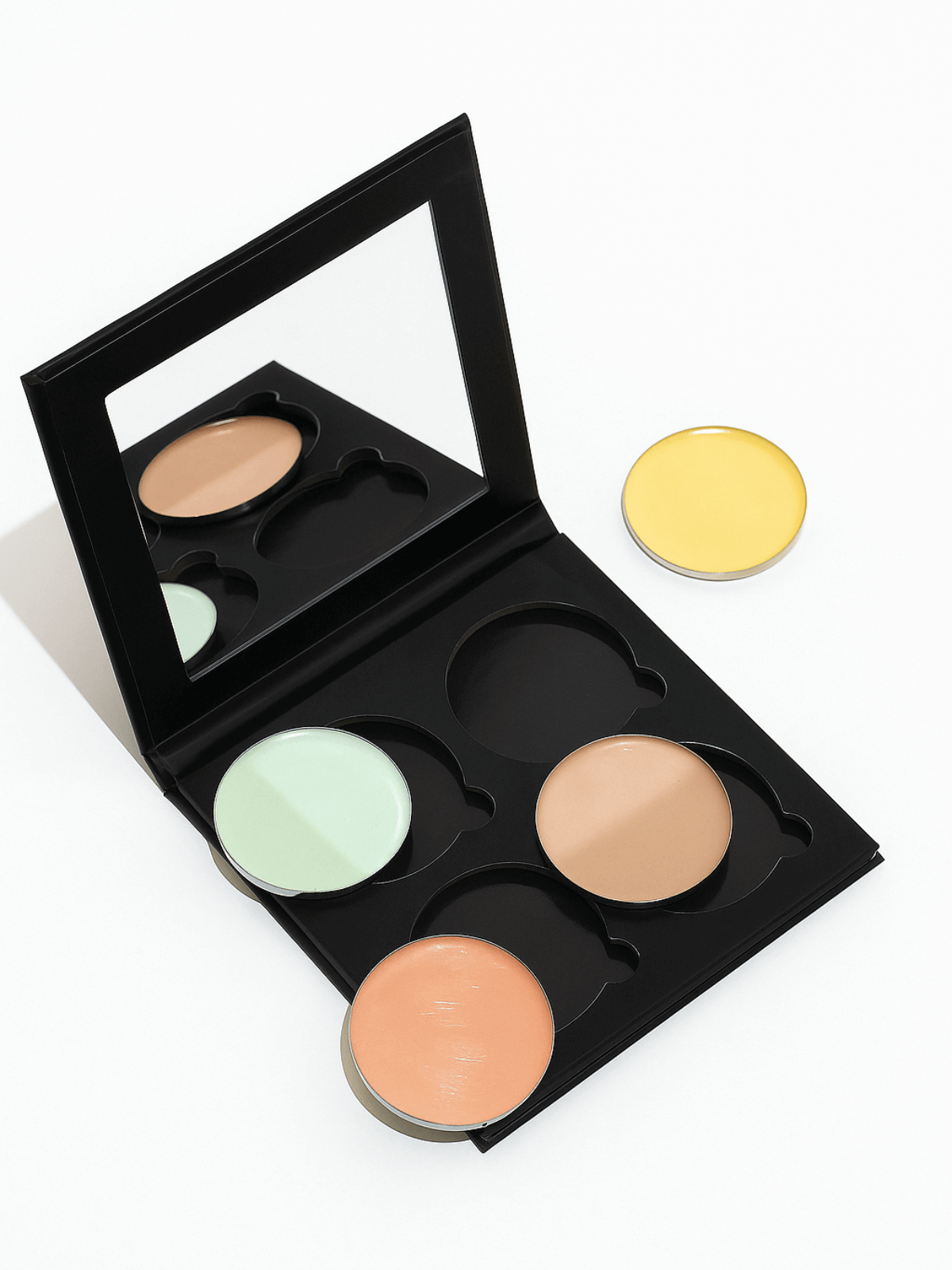 corrective concealer palette with four shades on a white background