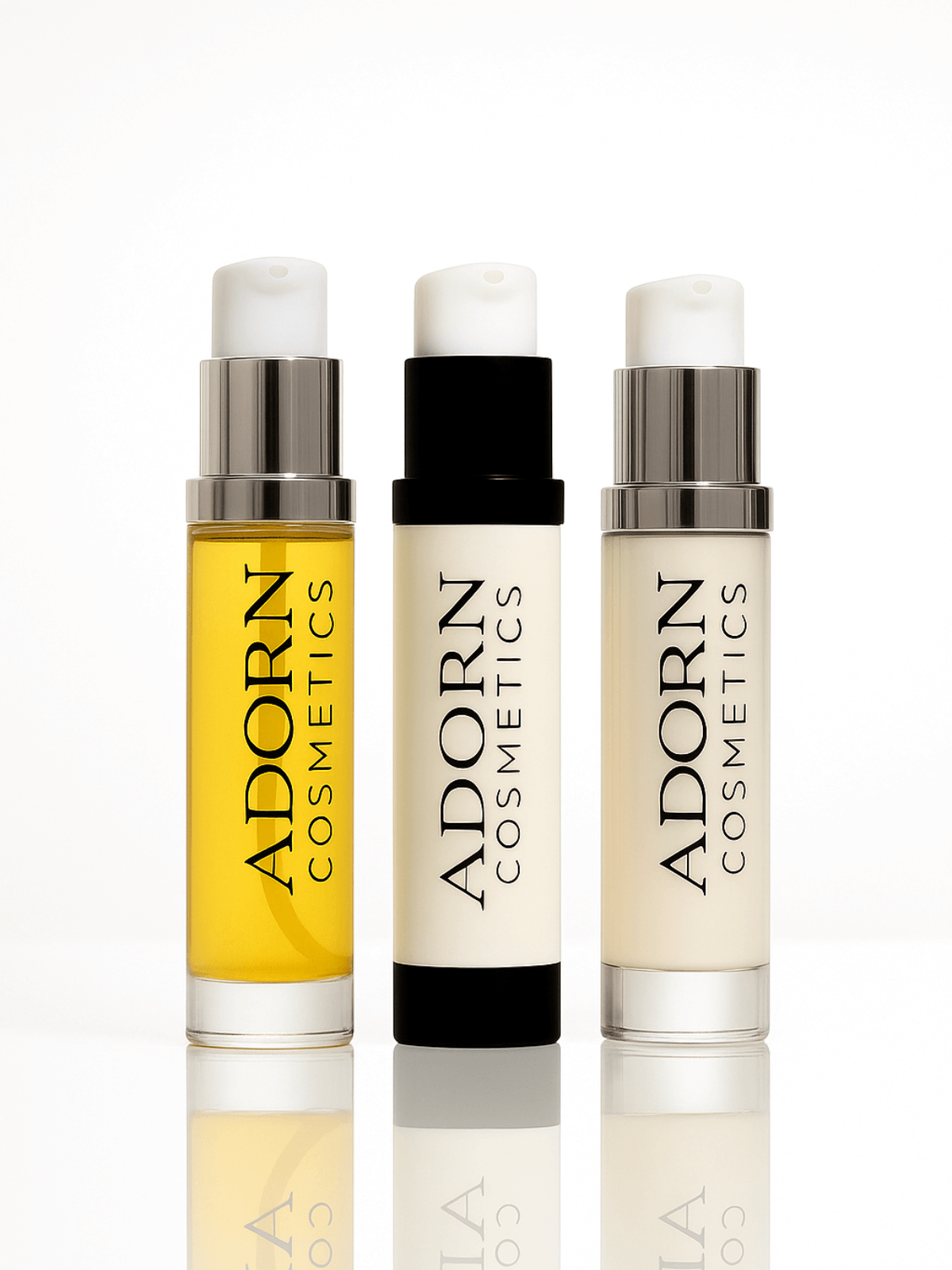 Three Adorn Cosmetics skincare travel size bottles in different colors on a white background