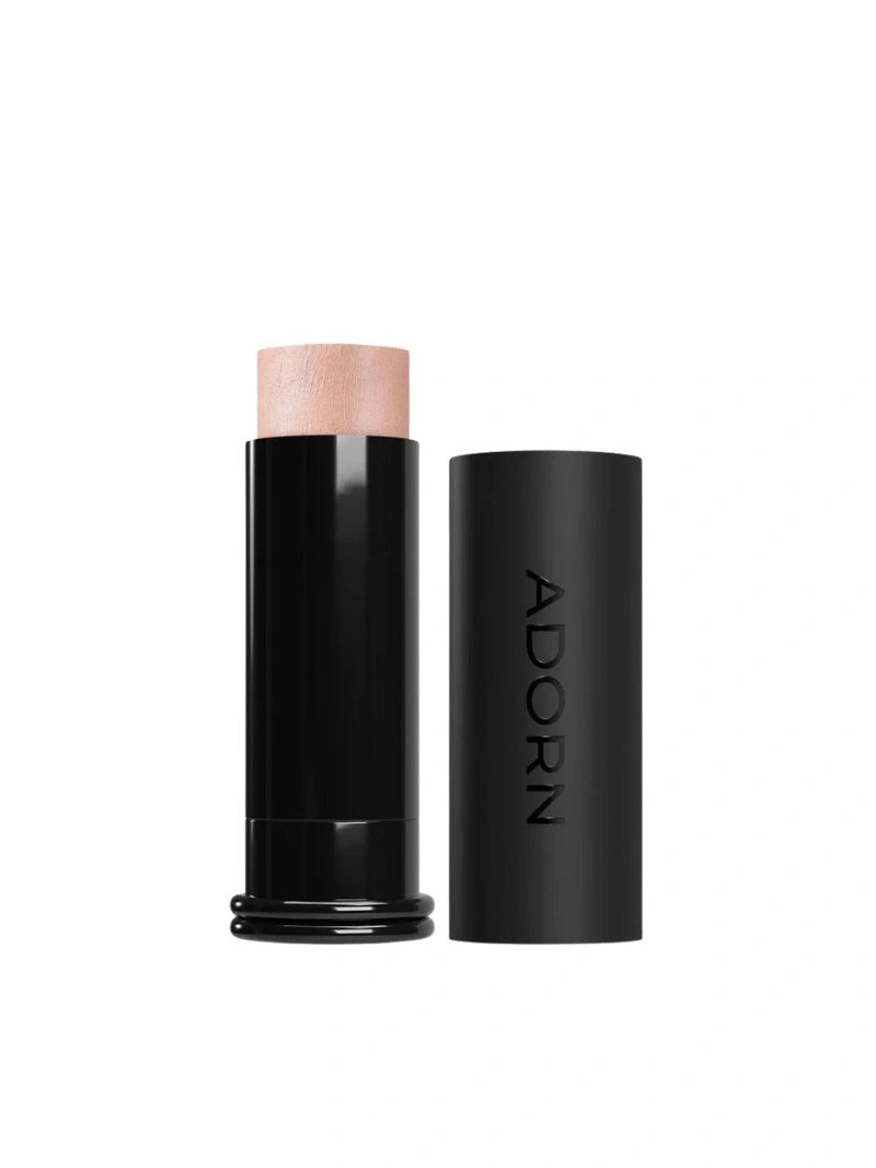 Makeup stick with pink top and black casing on a white background, branded 'ADORN'.