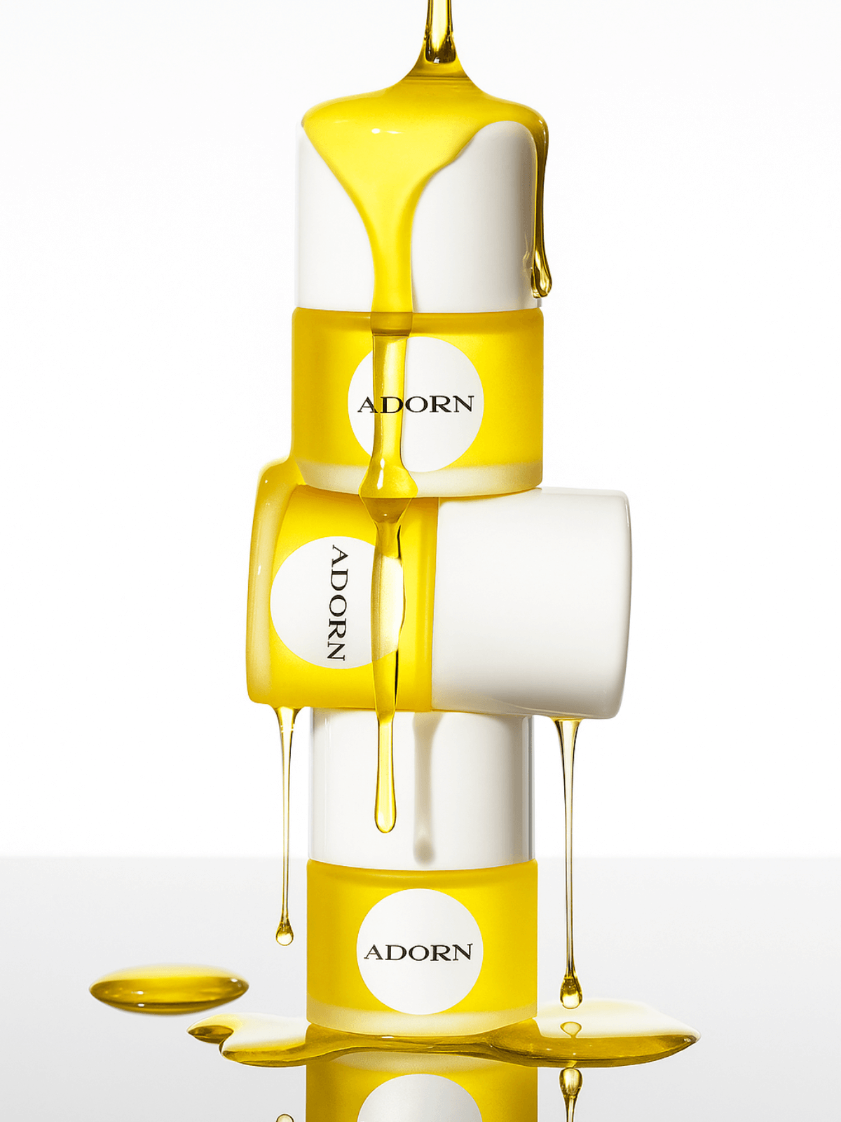 Sample bottles of 'ADORN' natural face oils for mature skin with natural oil dripping, on a white background.