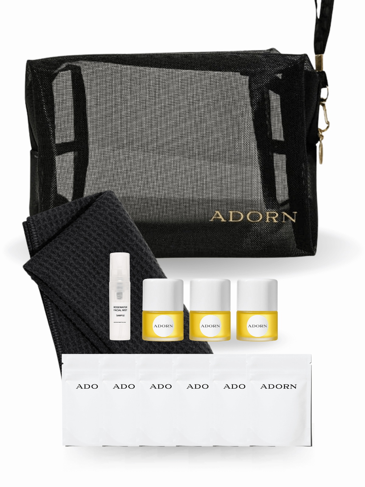 Cosmetic set with 'ADORN' branding including a black mesh bag, towel, and skincare products.