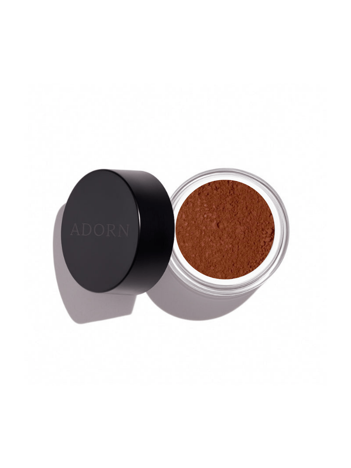 Open container of loose mineral eyeshadow shade spice with 'ADORN' branding on a white background