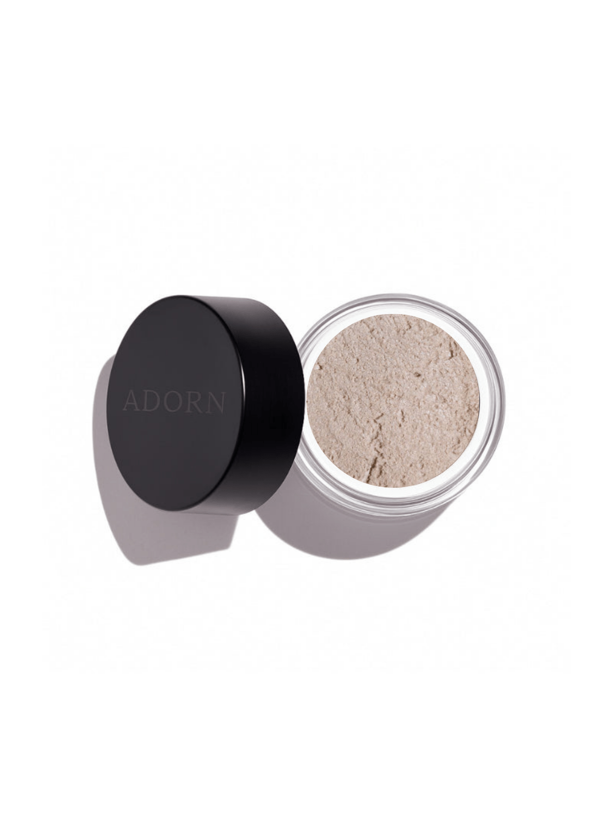 Open container of loose mineral eyeshadow shade invincible with 'ADORN' branding on a white background