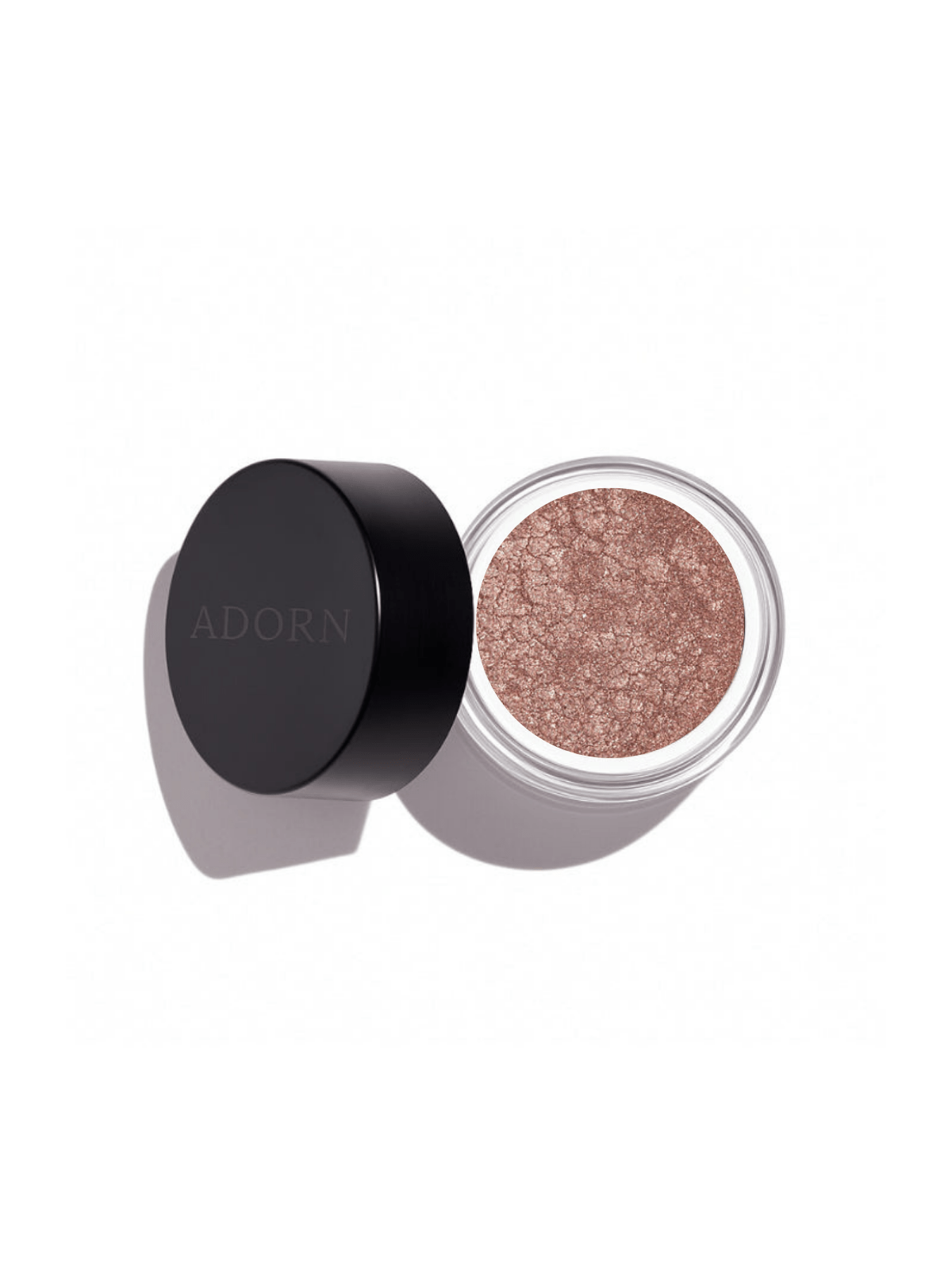 Open container of glittery makeup loose mineral eyeshadow shade obsidian with 'ADORN' branding on a white background
