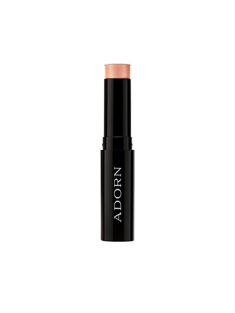 mineral highlighter stick with beige cap on a white background, branded 'ADORN'.