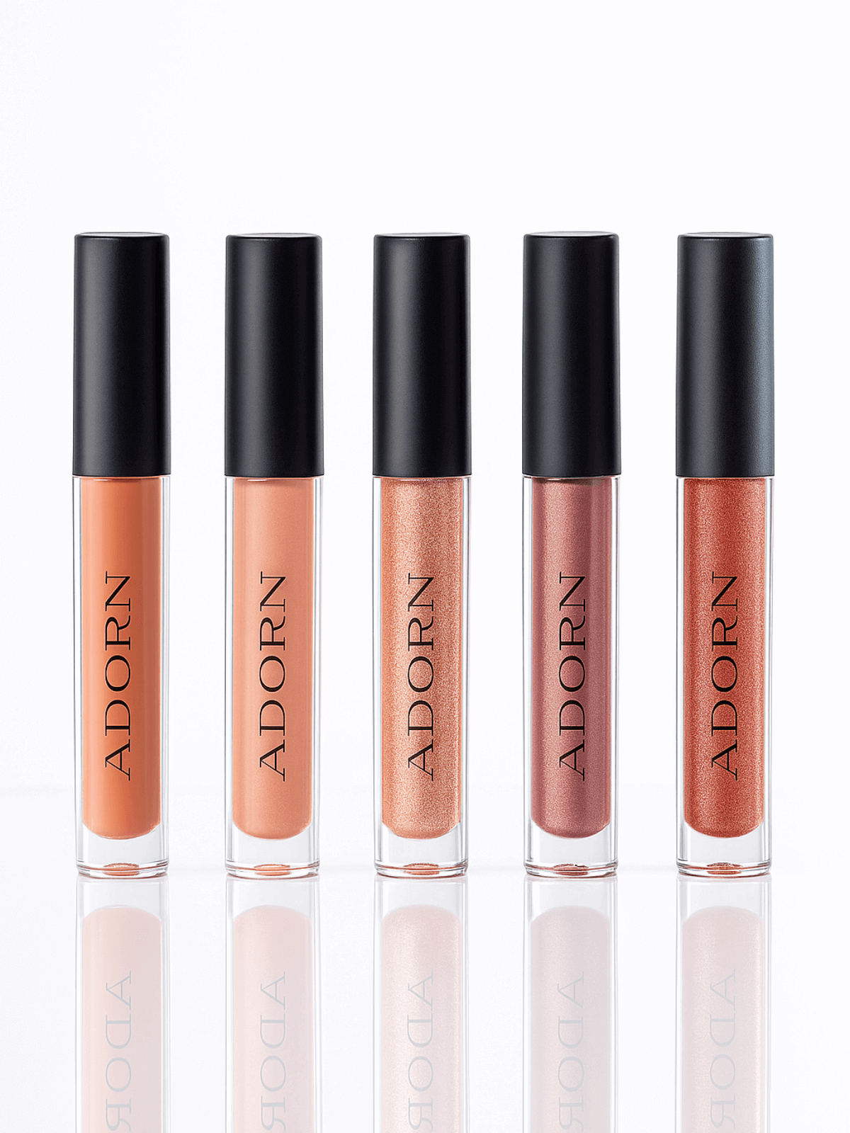 Five lip glosses with black caps labeled 'ADORN' on a white background