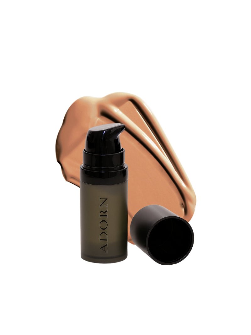 Cosmetic bottle with pump and cover on a white background, featuring the brand 'ADORN'.