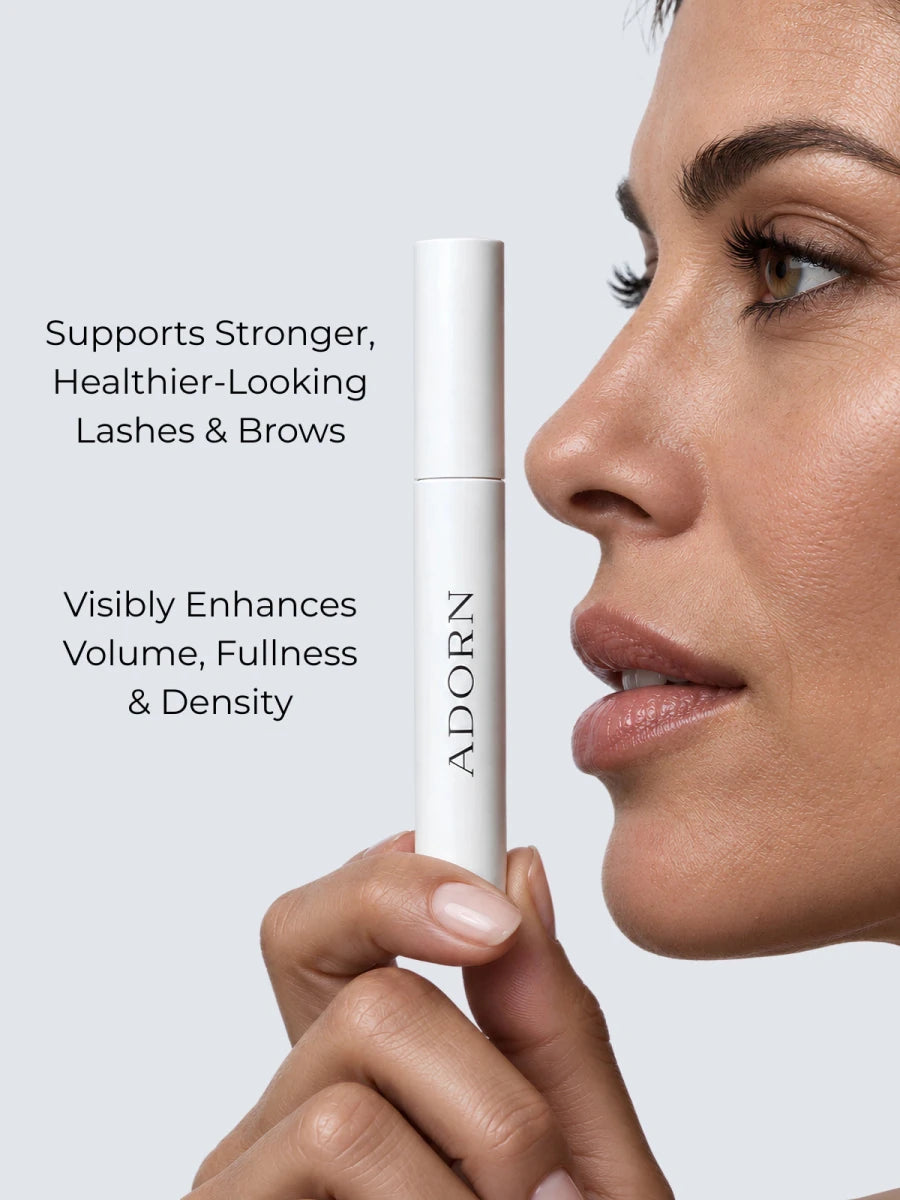 Woman holding Adorn peptide lash serum — supports stronger, fuller-looking lashes and brows