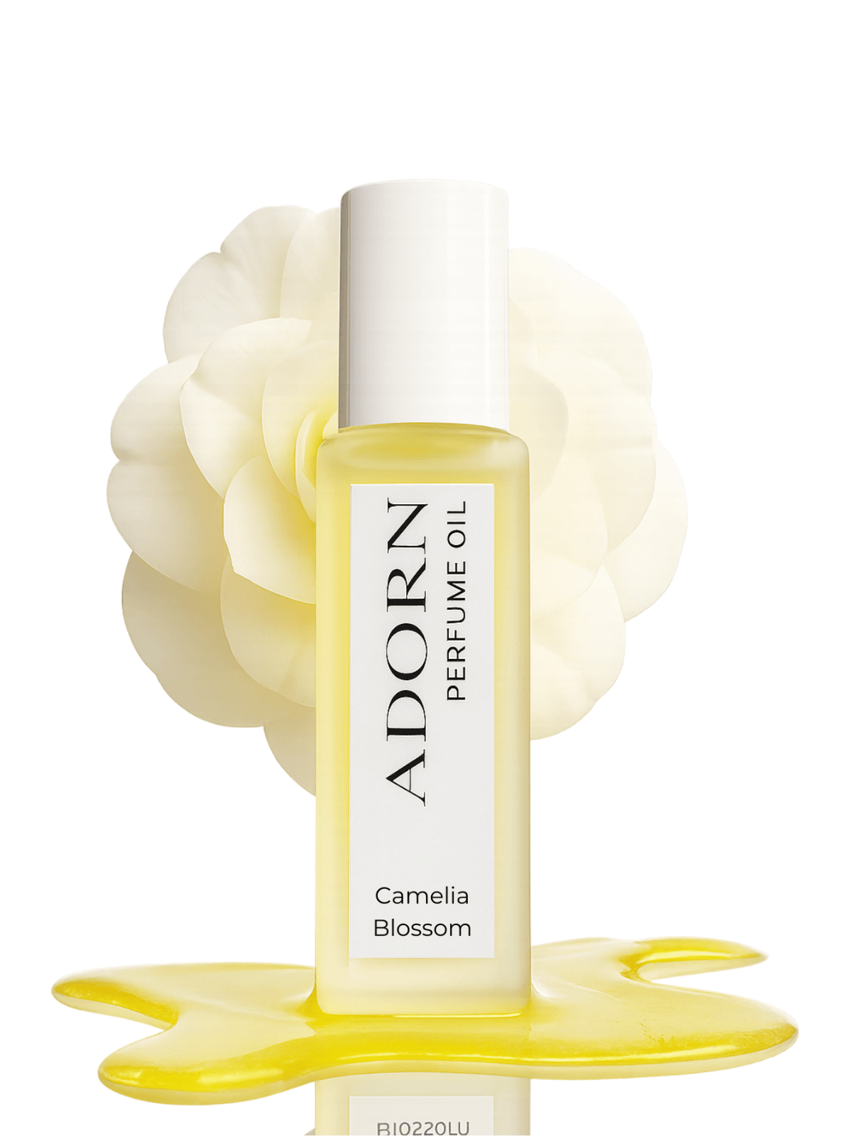 Roll on perfume oil bottle labeled 'Adorn' with a floral design on a white background