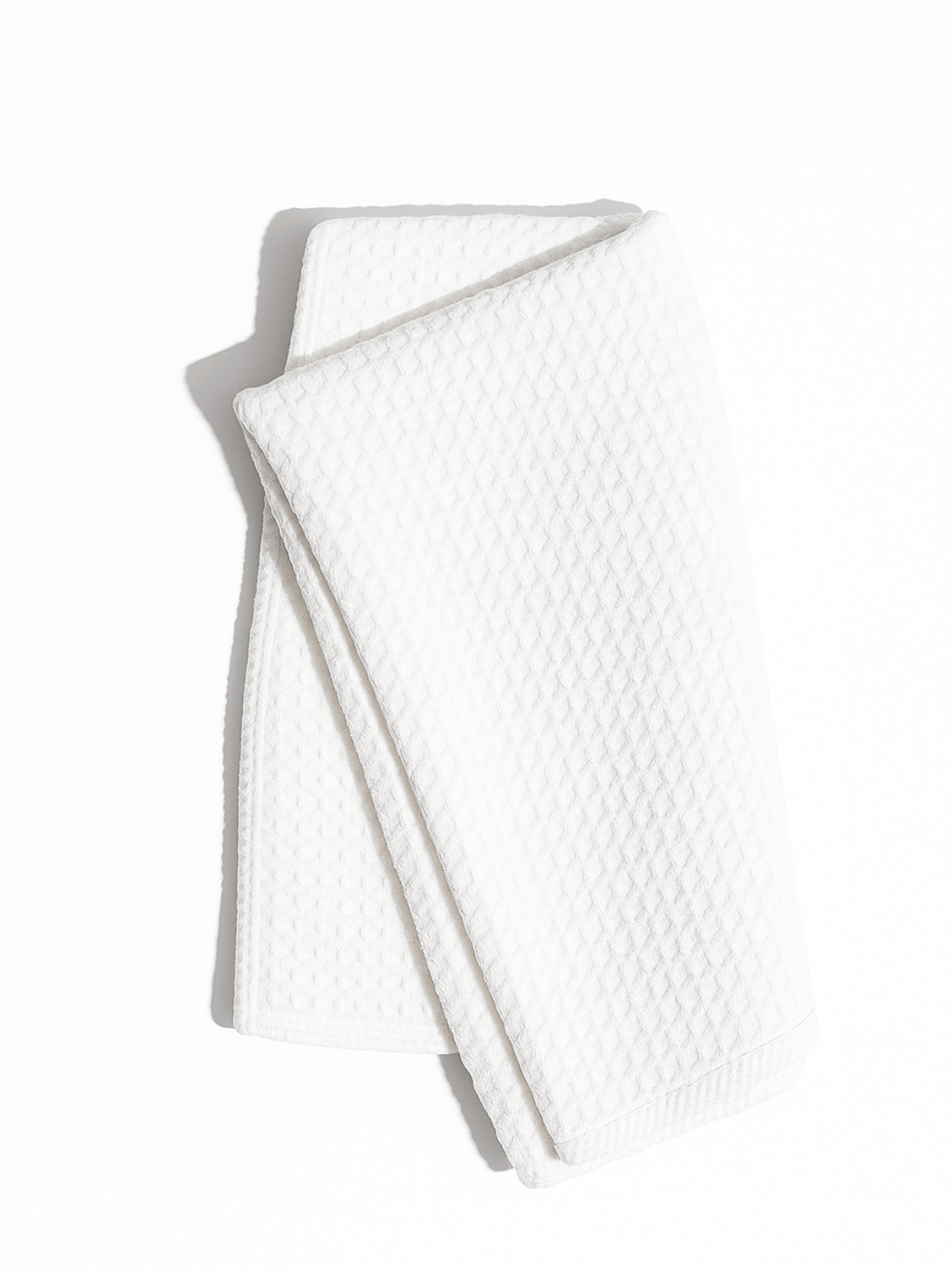 White textured exfoliating cloth for face on a white background from Adorn Cosmetics