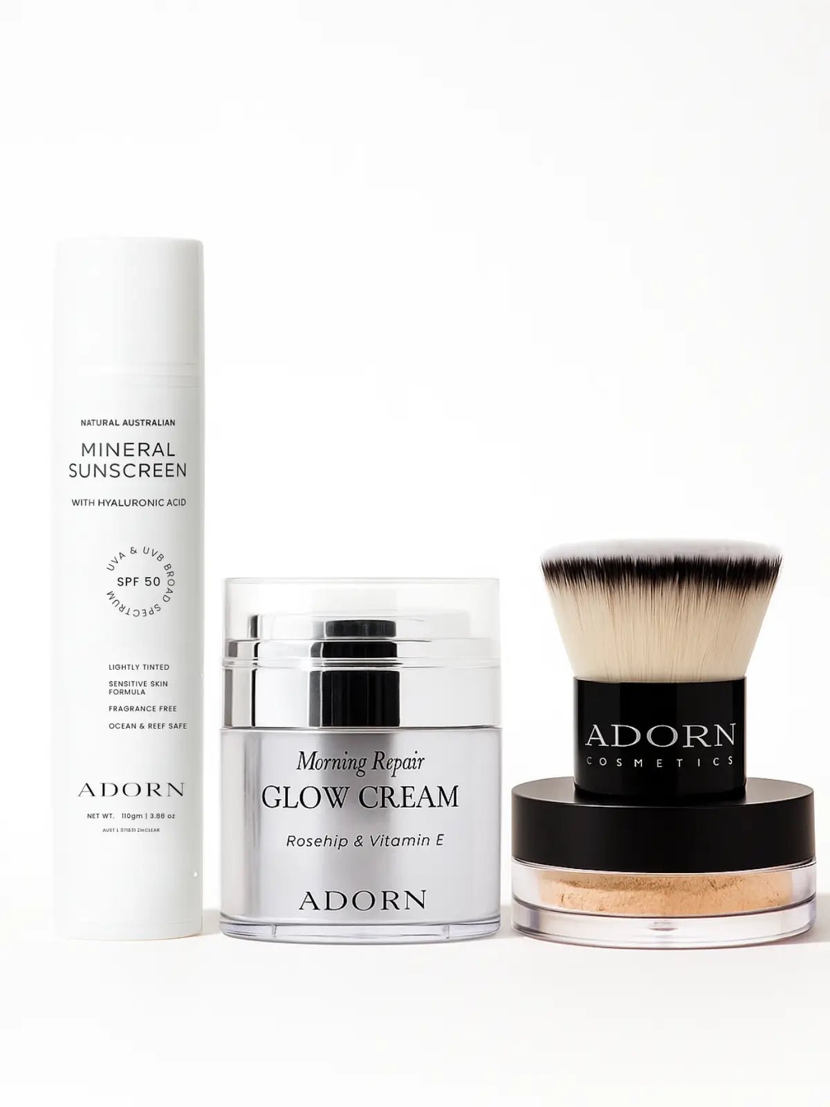 Collection of Adorn skincare products including a sunscreen, day cream, mineral foundation and foundation brush on a white background