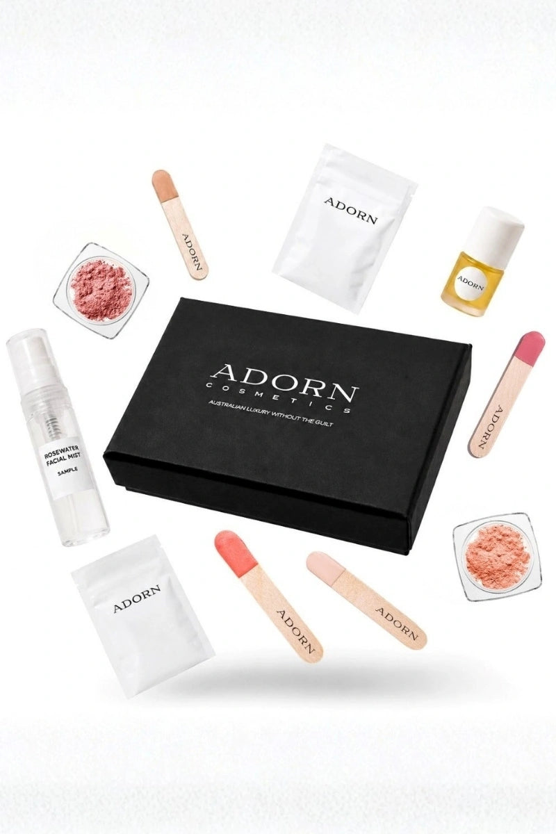 ADORN Cosmetics skincare and makeup samples with a black gift box.