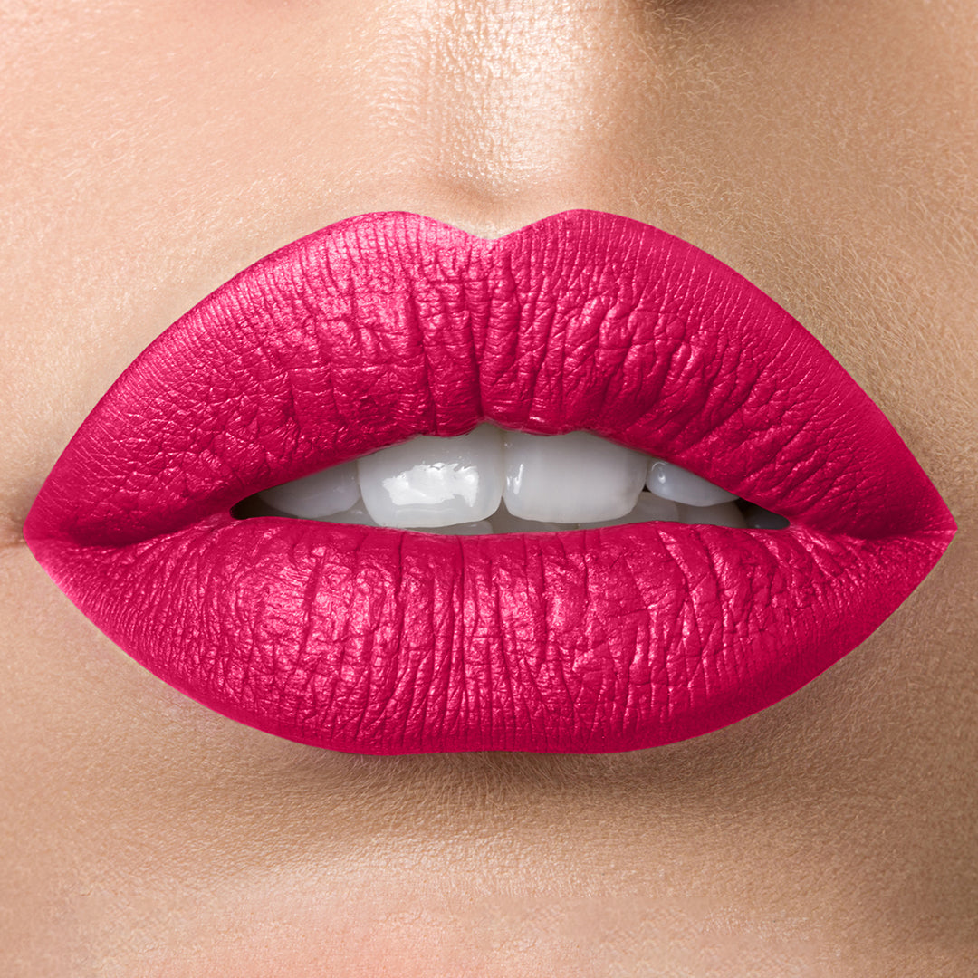 Close-up of bright pink lipstick on lips with a neutral background
