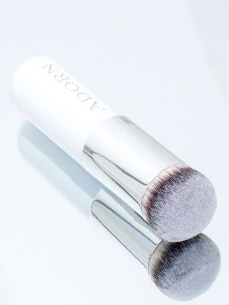 Cream makeup brush on a glass background from Adorn Cosmetics