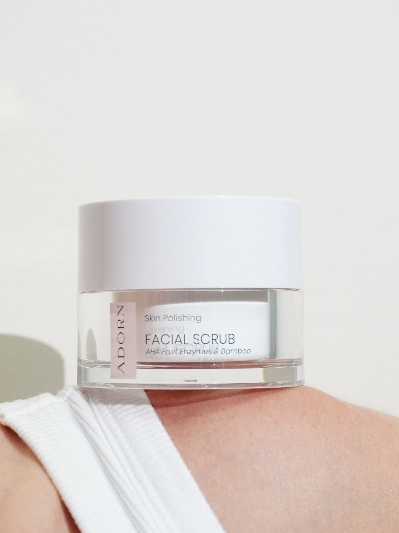 ADORN Bamboo + AHA Fruit Enzyme Face Scrub for aging skin on a model's shoulder, made by Adorn Cosmetics