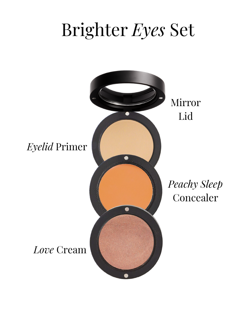 Makeup stack with eyelid primer dark circle concealer and cream blush set on a white background from Adorn Cosmetics.