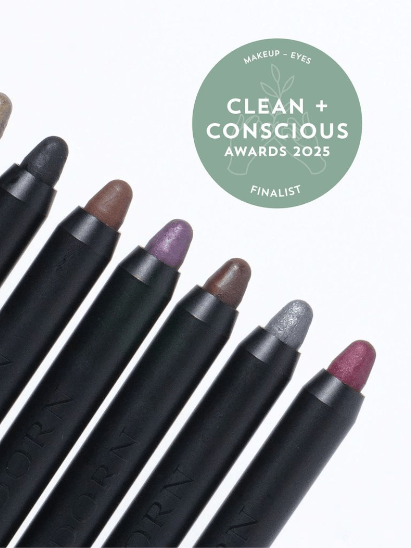 Makeup pencils with various colors on a white background, featuring the Clean + Conscious Awards 2025 logo.