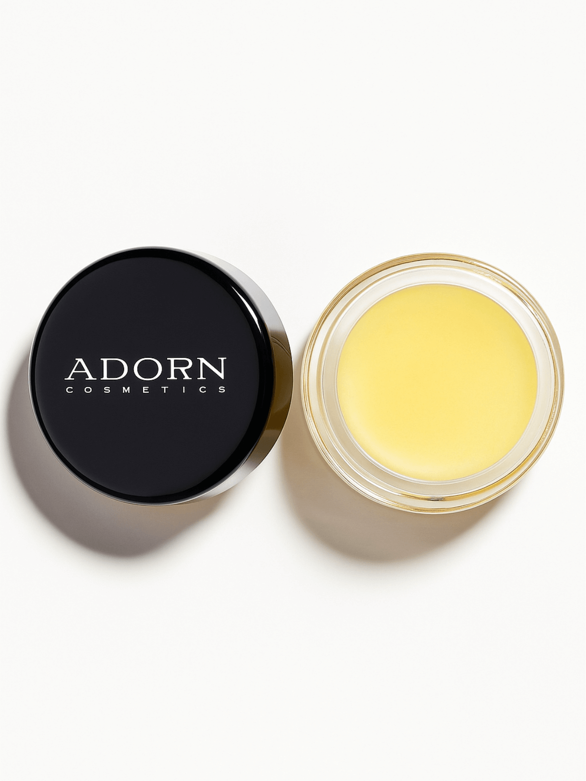 Adorn Cosmetics makeup cleansing balm in a black travel pot on a white background