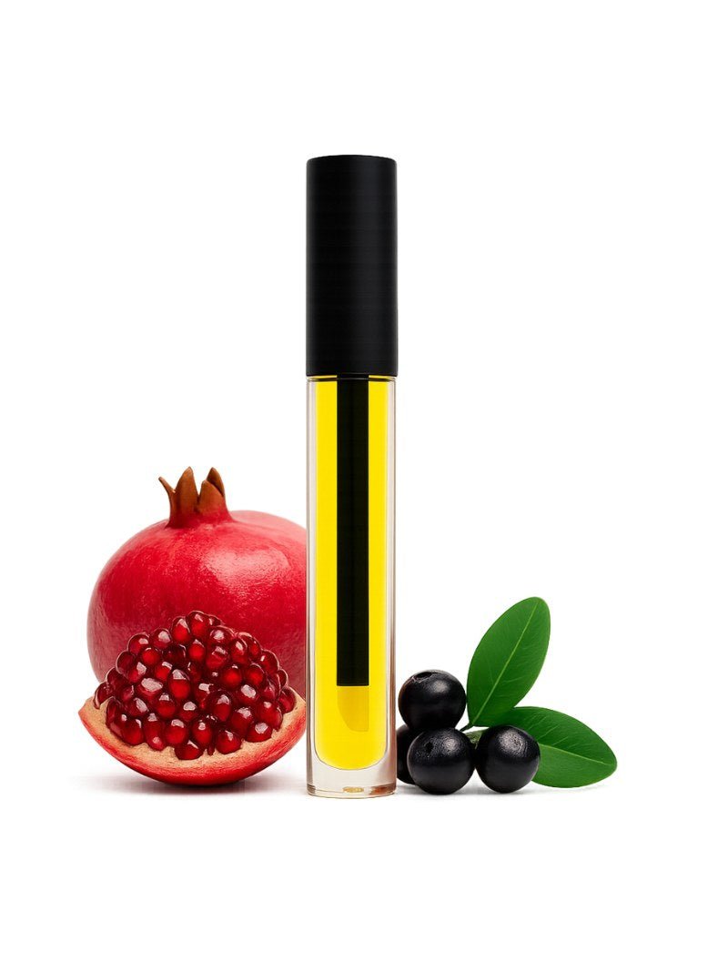 organic oil Australia next to a pomegranate, acai berry, and leaves on a white background.