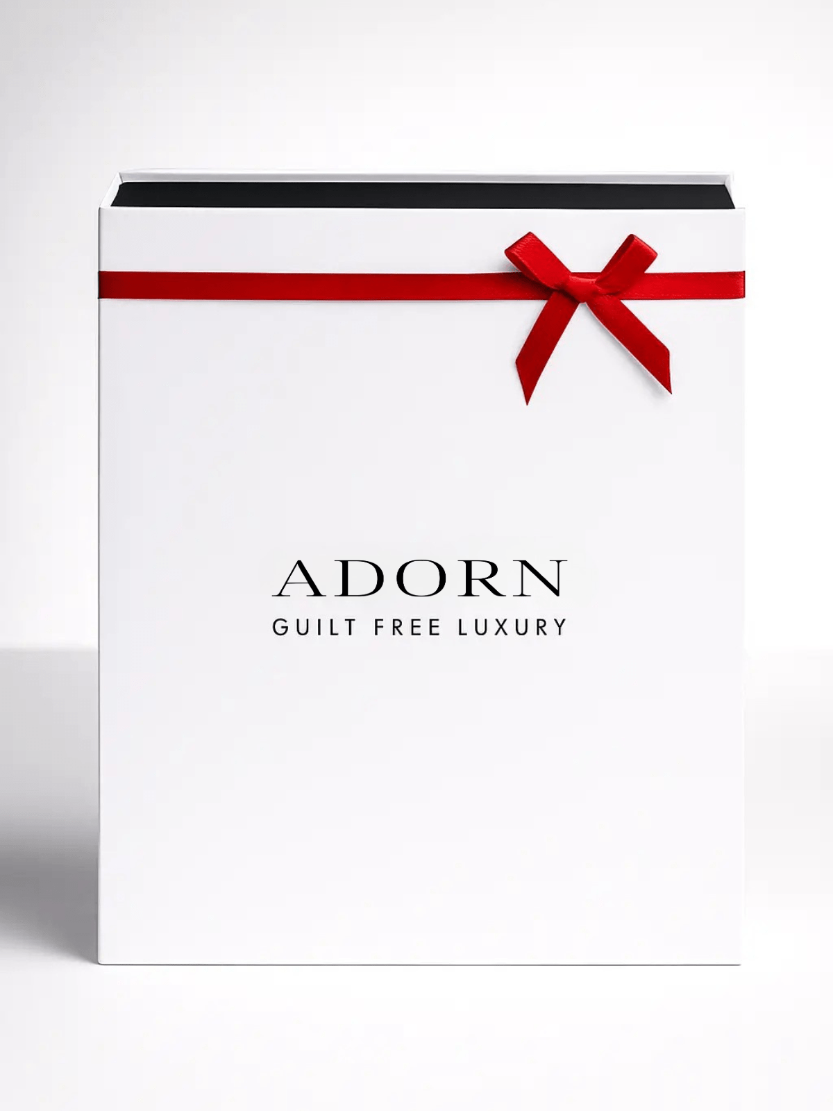 Christmas Advent Calendar Beauty gift box with a red ribbon and 'Adorn' branding on a light gray background.