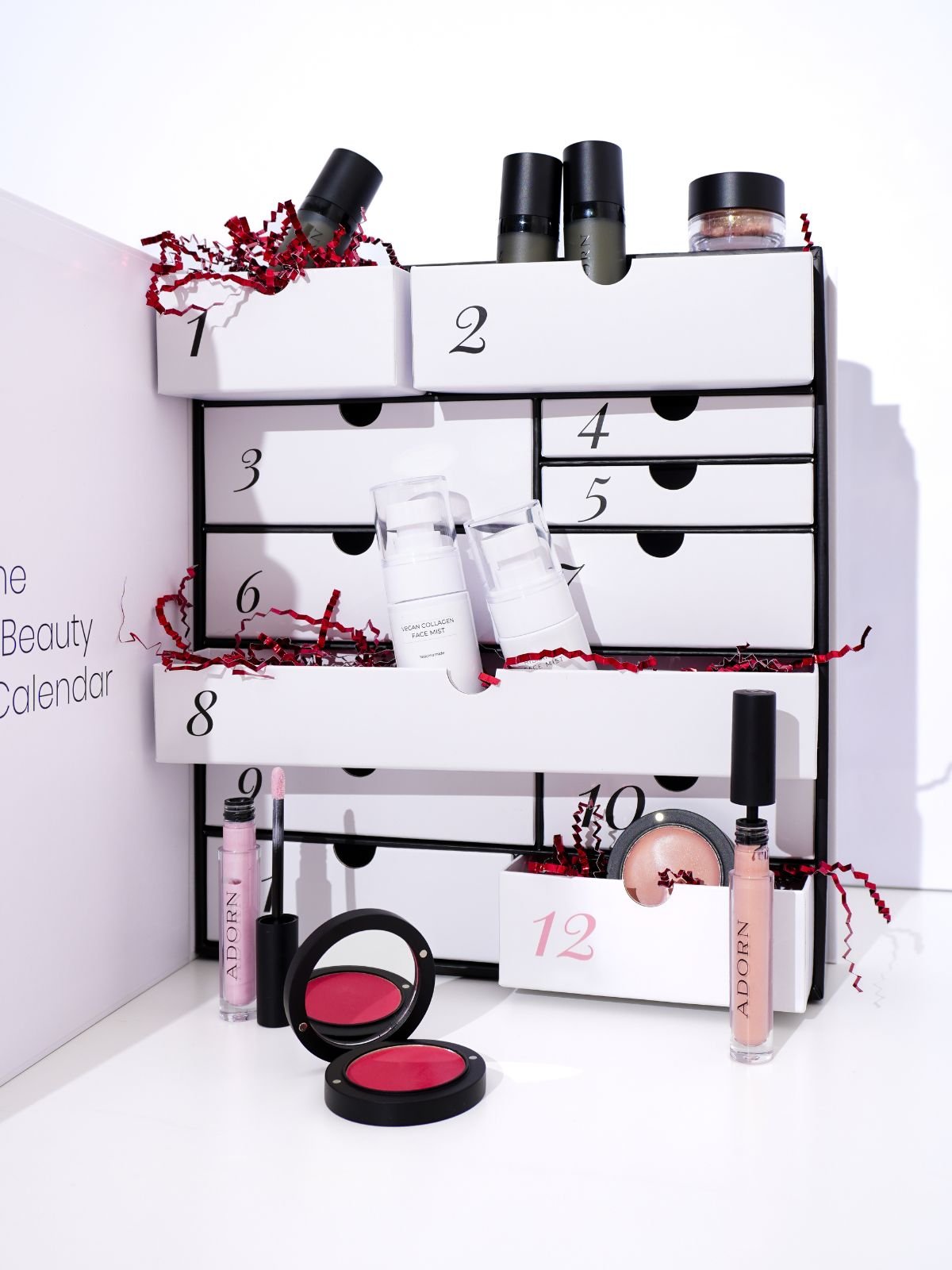 advent calendar beauty with various cosmetic products on a white background
