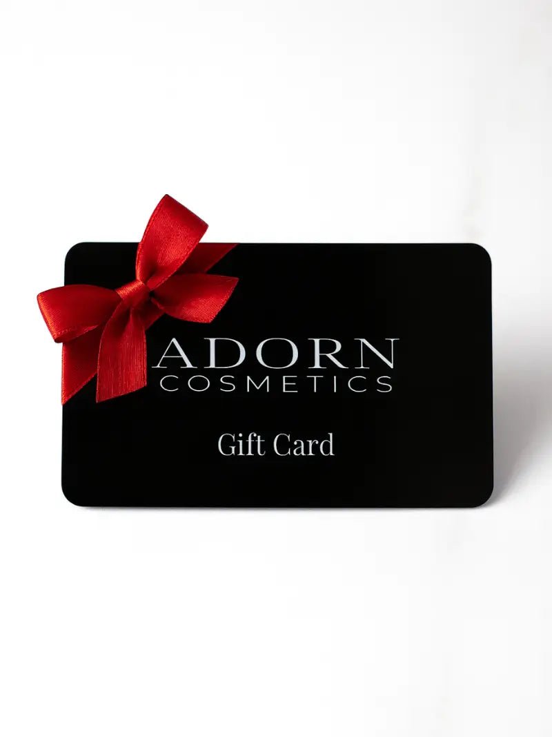 Adorn Cosmetics gift card with a red bow on a white background
