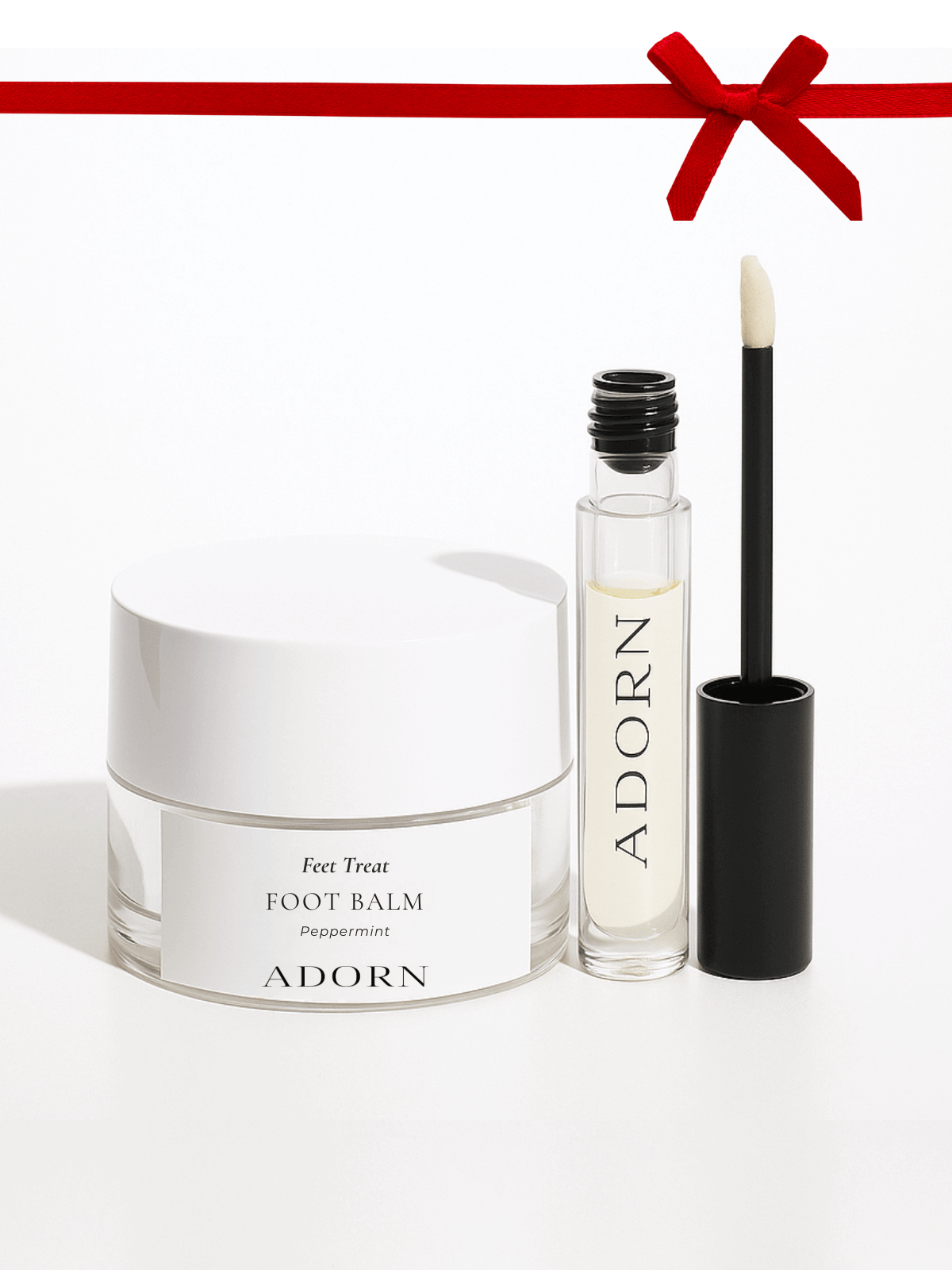 Foot balm and rollerball with 'ADORN' branding on a white background