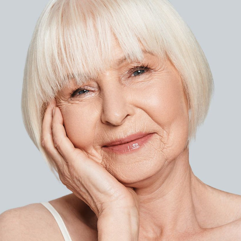 mature woman wearing natural pink lipstick by Adorn Cosmetics
