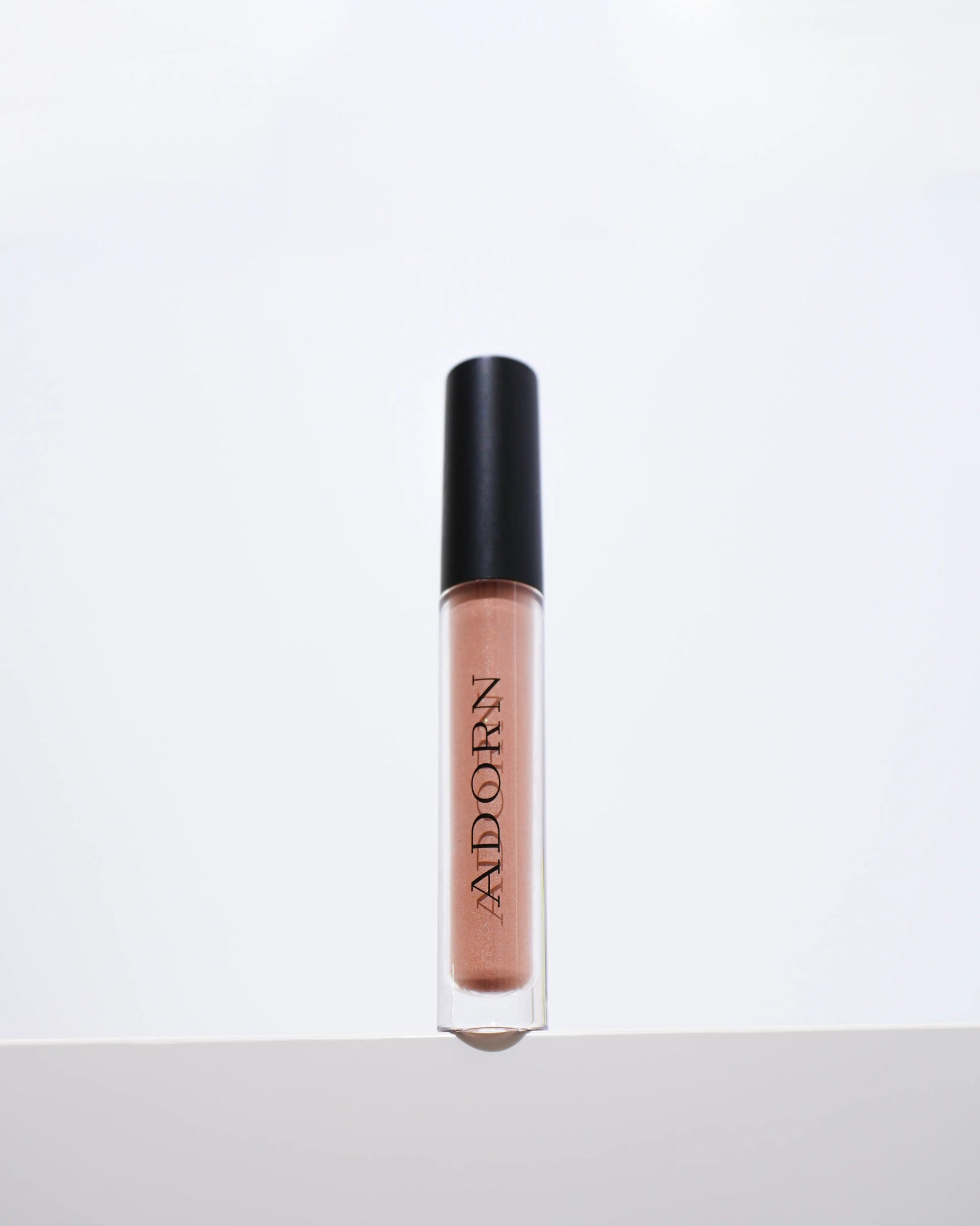Liquid blush with black cap on a white background