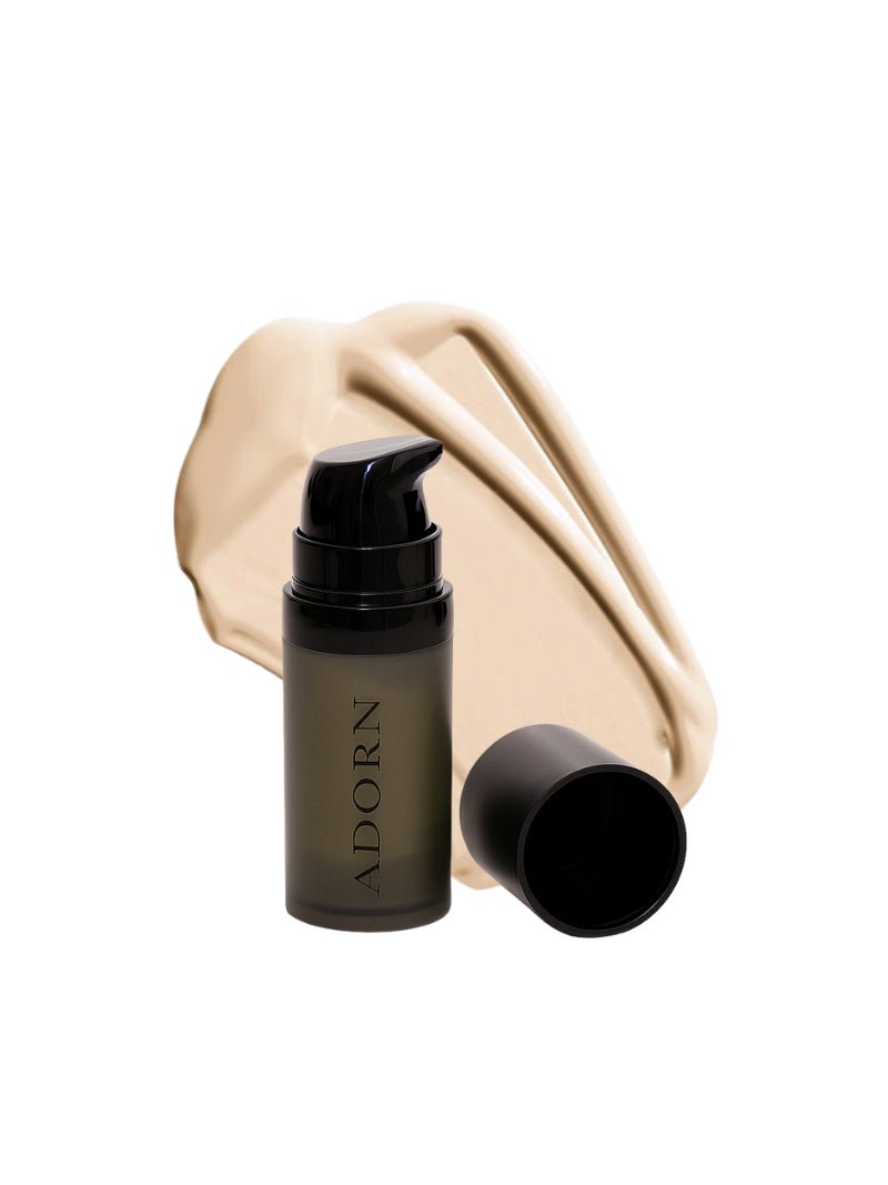 Cosmetic bottle labeled 'ADORN' with a beige fabric background