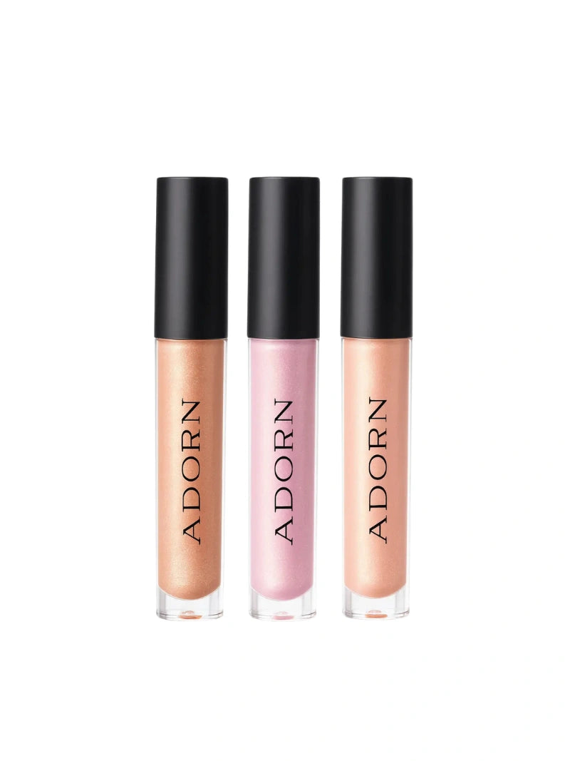 Three lip glosses with 'ADORN' branding on a white background with a red ribbon at the top.