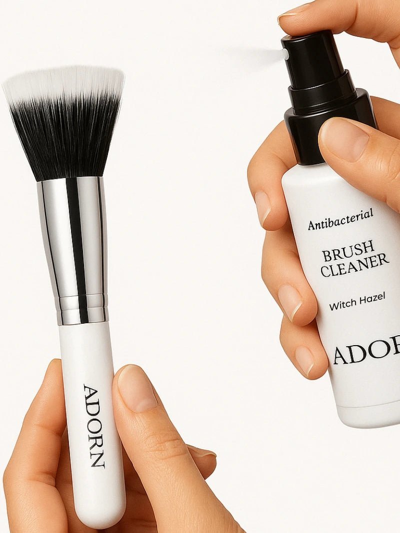 Makeup brush and bottle of ADORN brush cleaner on a white background