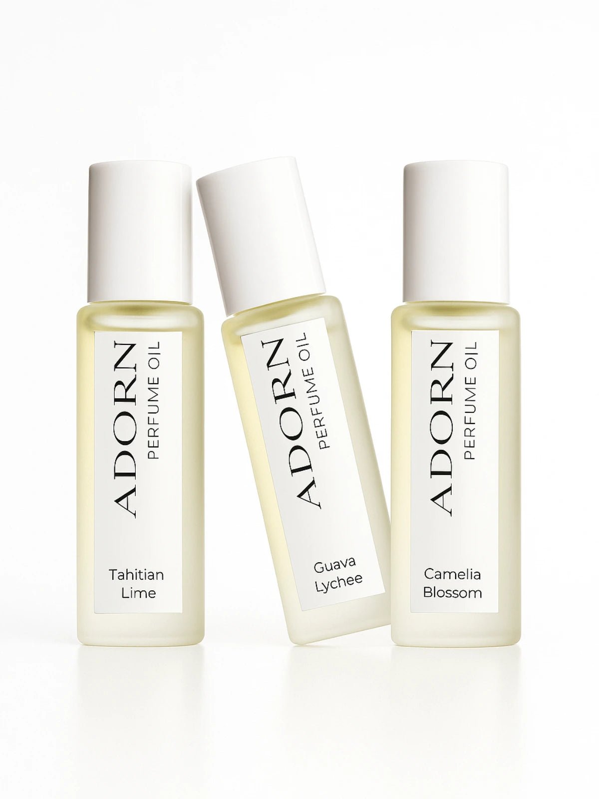 Three Adorn Perfume Oil bottles on a white background
