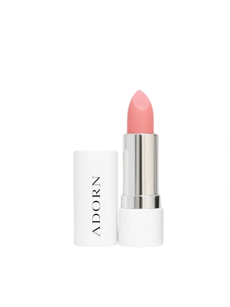 Pink lipstick with white container labeled 'ADORN' on a white background