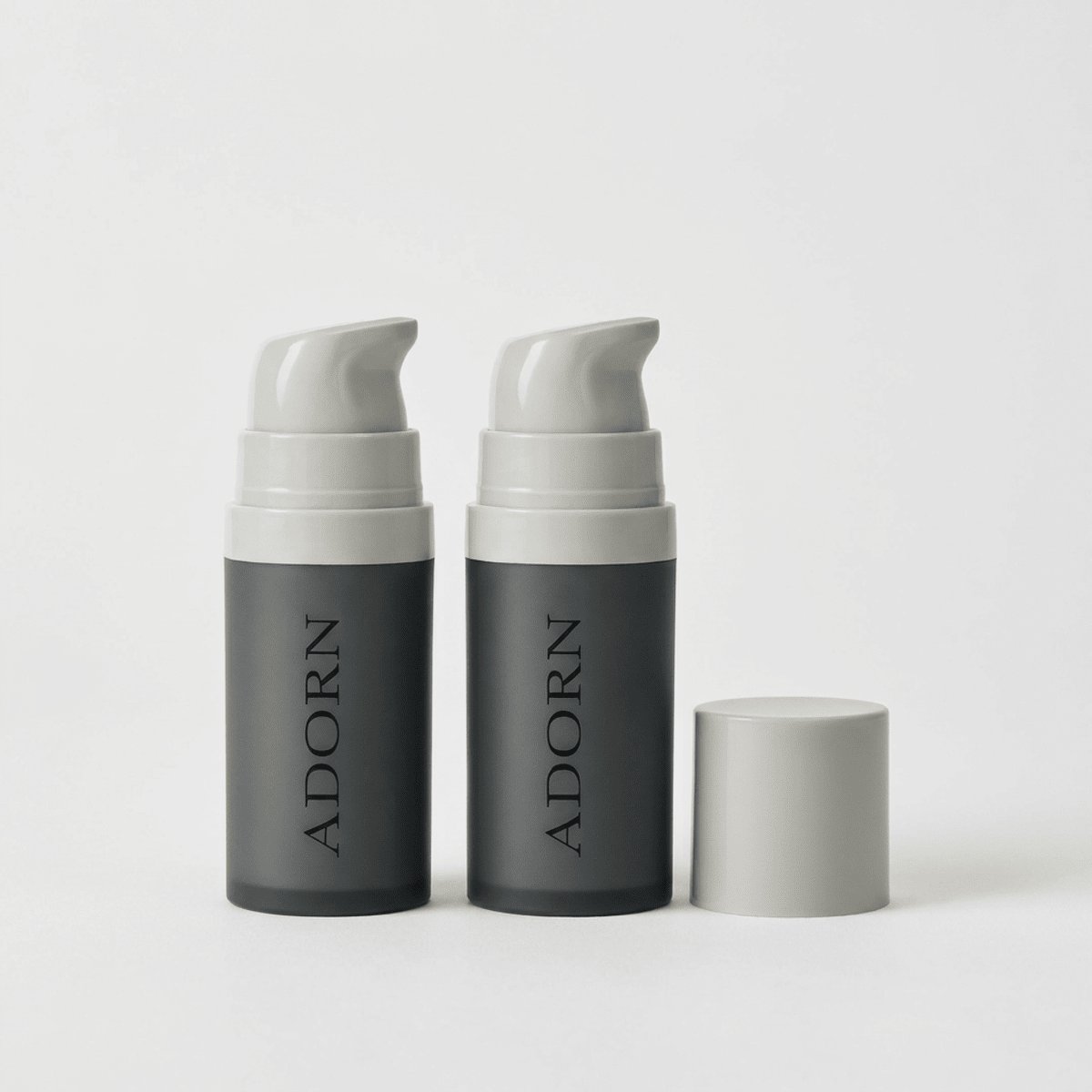 Two Adorn Hyaluronic Acid Eye Cream pump bottles with caps in the pre-order bundle