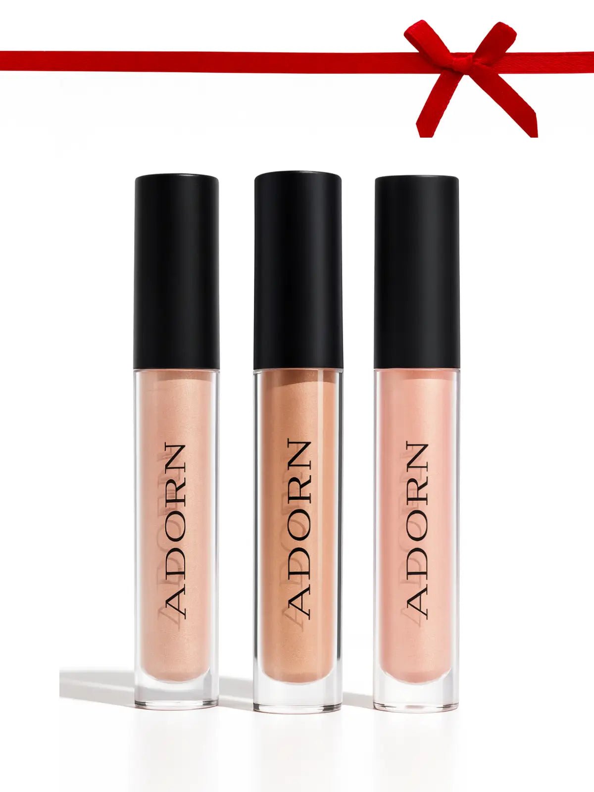 Liquid blush, liquid bronzer and mineral illuminator with 'ADORN' branding on a white background with a red ribbon at the top.