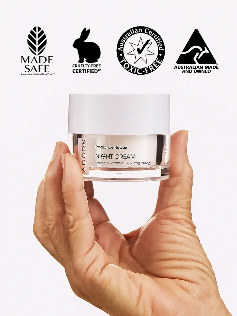 Hand holding a jar of best night cream for glowing skin with certification logos on a white background